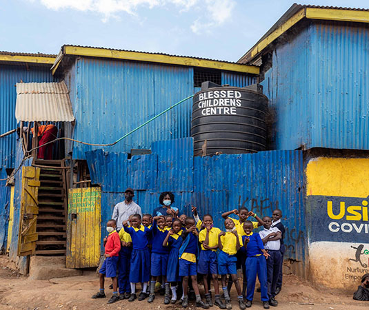 group of students outside blessed childrens center in kenya