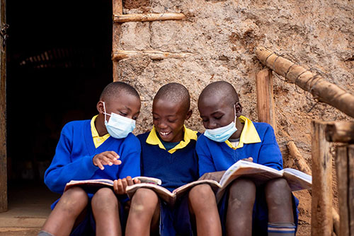 kenyan students smiling with new textbooks