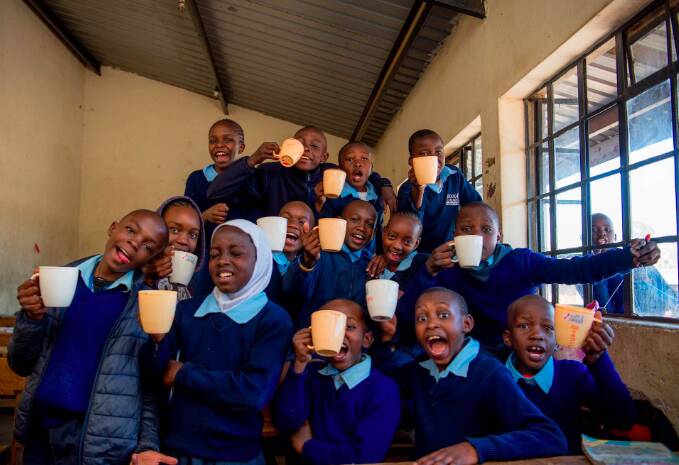students with their morning porridge at the Kicoshep school
