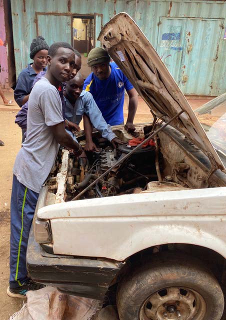 students working on a car's engine