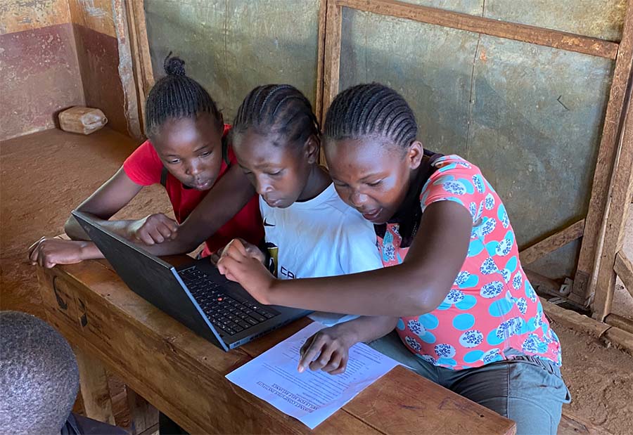 three young students going through a coding exercise at coding camp