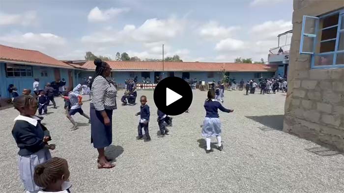video still of a group of students playing outside St. Catherine's school near Nairobi Kenya