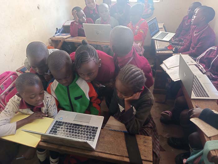 group of red hill students working on laptops